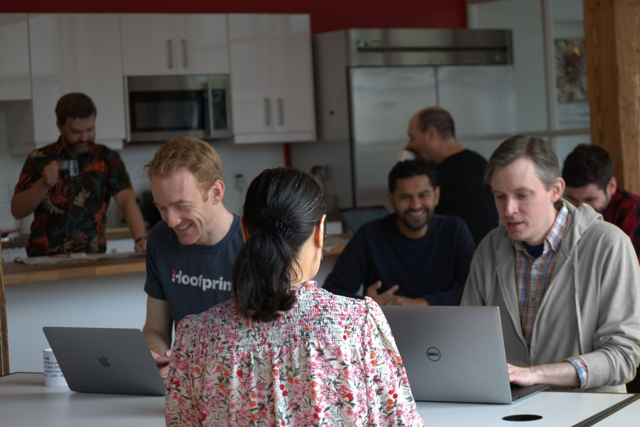 Uncharted team members working and socializing in the company's cafe-style kitchen